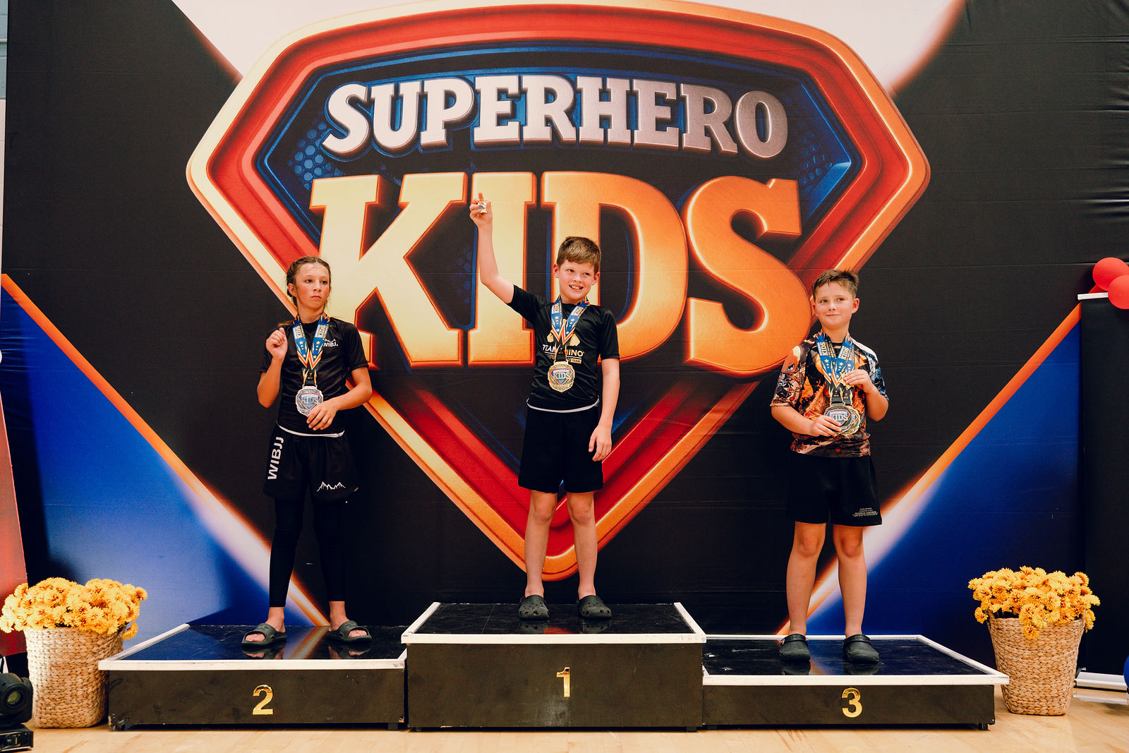 Superhero Kids athletes with their coach